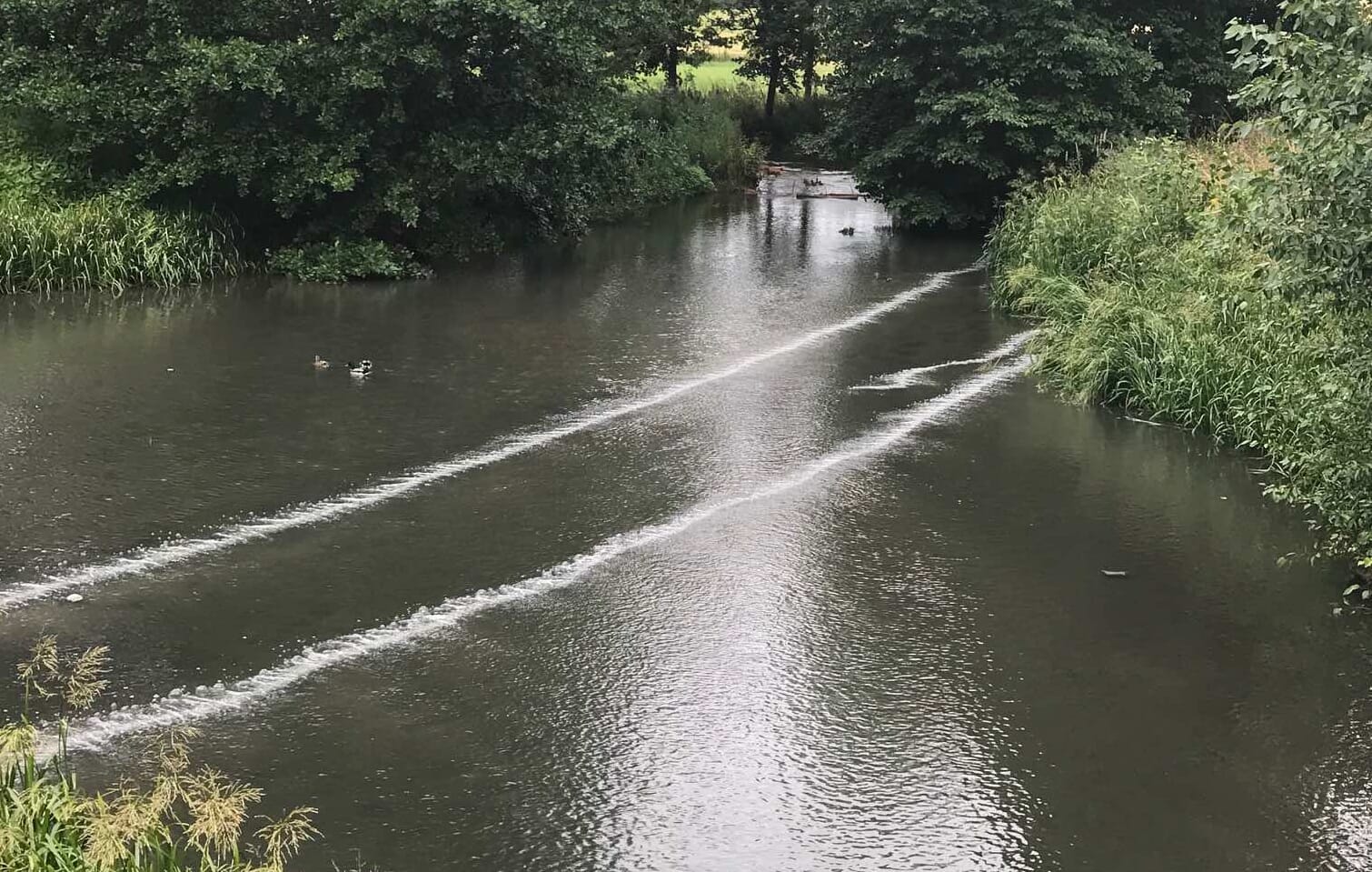 Bubbles Tubing creating a curtain across a water body
